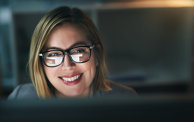 Image showing Happy, businesswoman and working late on a computer or overtime for a project deadline or schedule and in an office. Research, email and corporate worker with smile or analysis and report at night