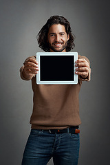 Image showing Portrait, tablet screen and happy man with mockup in studio isolated on a gray background. Touchscreen, face and male person with marketing, advertising and technology for commercial promotion space.