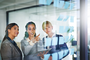 Image showing Business people, teamwork or creative women writing on board for brainstorming a solution, ideas or goals. Planning, sticky note or creative group talking or speaking project collaboration together