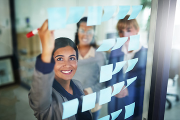 Image showing Business people, teamwork or happy woman writing on board for brainstorming a solution, ideas or goals. Planning, sticky note or creative group with leadership for project collaboration together