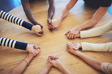 Image showing Circle, group and holding hands with people, pray and support for faith, trust or solidarity on desk. Teamwork, helping hand and together with praying, religion or gratitude with mindfulness on table