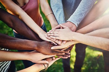 Image showing Hands, diversity and friends at a park for teamwork, partnership and volunteering mission from above. Top view, people and hand support by volunteer group outdoor for community, charity and activism