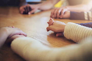 Image showing Circle, group and holding hands with people, praying and support for faith, trust or solidarity on desk. Teamwork, helping hand and together with pray, religion or spiritual with mindfulness on table