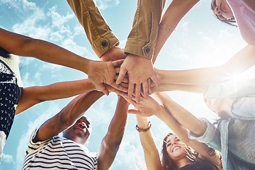 Image showing Team building, hands and low angle of business people in solidarity or partnership on blue sky background. Teamwork, agreement and below hand collaboration for motivation, help or friends celebration