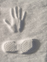 Image showing Snow imprint of human hand and foot