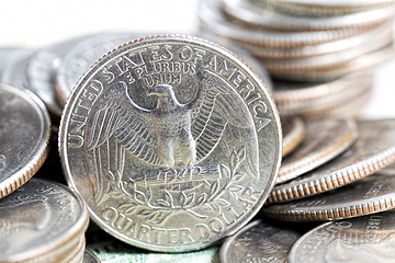 Image showing a stack of American twenty-five-cent coins, a close-up of American coins