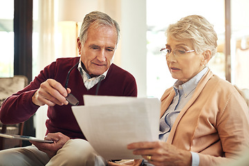 Image showing Financial, insurance and reading with an old couple in their home for retirement or pension planning. Accounting, money debt or investment with a senior man and woman in a house for finance budget