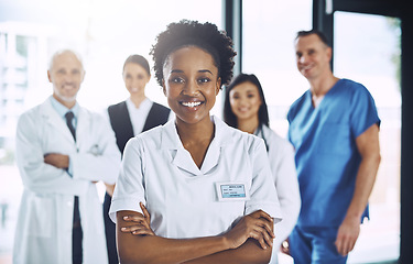 Image showing Leadership, teamwork and portrait black woman with doctors, nurses and smile in hospital. Healthcare, diversity and medicine, doctor with arms crossed and team of medical employees together in clinic