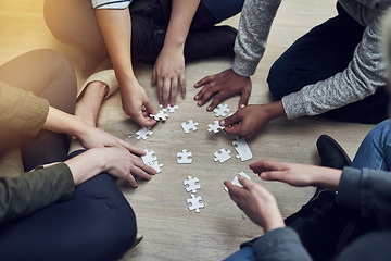 Image showing Hands, business people and puzzle in circle, diversity or teamwork for problem solving, solution or above game. Group, planning and helping hand for support, synergy and team building on office floor