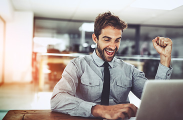 Image showing Business man, fist and celebration with laptop, winning or promotion at startup with excited face. Young businessman, winner and celebrate with computer, bonus or profit on investment on stock market