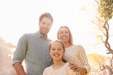 Image showing Nature, sunshine and happy portrait of family, parents and child support, bonding and enjoy outdoor quality time together. Sky, spring flare and happiness of mother, father or kid smile for love care