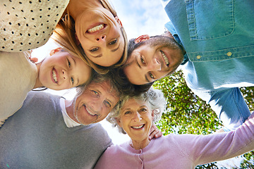 Image showing Face portrait, smile and circle of happy family hug, grandparents and parents bond with kid in nature park. Solidarity care, blue sky or bottom view of people smile in garden, forest or outdoor woods