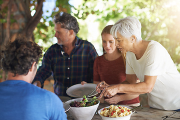 Image showing Food, party and salad with family at lunch and serving for health, bonding and celebration. Vacation, social and event with parents and children eating together for dining, generations and wellness