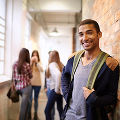 Image showing University, education and portrait of man on campus ready for study, knowledge and learning. Scholarship, happy and face of male student in hallway with friends for school, academy and college class