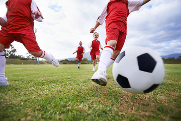 Image showing Running, teamwork and closeup with children and soccer ball on field for training, competition and fitness. Game, summer and action with football player and kick on pitch for goals, energy or athlete