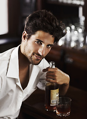 Image showing Man, pub counter and portrait with drink at happy hour with alcohol and whiskey after work. Bottle, male person and face of a handsome guy with a glass and style and confidence in a luxury bar