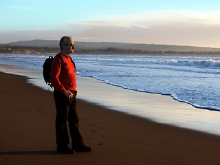 Image showing Man enjoying sunset by the ocean