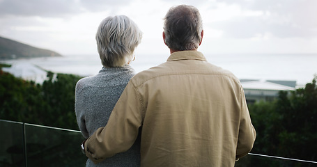 Image showing Love, back and senior couple on a balcony enjoying the outdoor view while on a holiday or vacation. Travel, cloudy weather and elderly man and woman on a retirement weekend trip by a resort house.