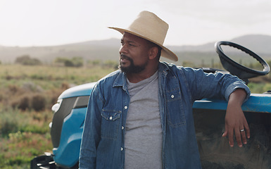 Image showing Farming, thinking and a black man with a tractor on a farm for agriculture growth and sustainability. Idea, planning and an African farmer in the countryside with ideas for sustainable business