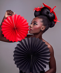 Image showing Art, makeup and creative with black woman in studio for origami, beauty and culture. Traditional, cosmetics and paper design with female model and fans on grey background for fashion, retro or color