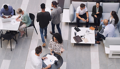 Image showing Top view, group and business people in a meeting, conversation and modern office with development. Staff, coworkers and team at a conference, share ideas and relax on a break, talking and teamwork