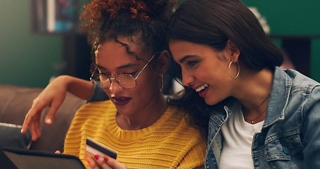 Image showing Girl friends, smile and credit card with tablet on a living room sofa with online shopping. Student, happiness and young woman together with web purchase and ecommerce payment app on a home lounge