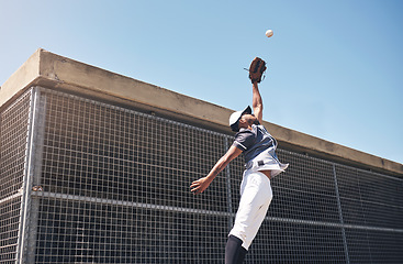 Image showing Baseball, catch and man jump for ball in air at pitch for sports competition, action or game. Professional african athlete person playing outdoor for training, exercise and focus on fitness for sport