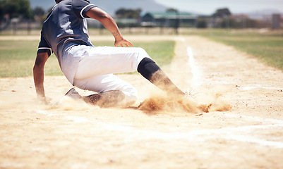 Image showing Baseball player, running slide and man on a base at a game with training and dirt. Dust, sport and male athlete outdoor on a field with exercise and run to safe box of runner on sand with competition