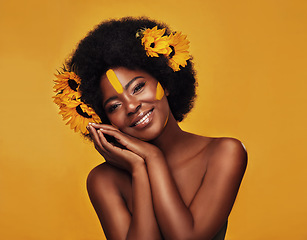 Image showing Natural, hair and sunflower with portrait of black woman in studio for beauty, creative or spring. Makeup, cosmetic and floral with face of model on yellow background for art, self love or confidence