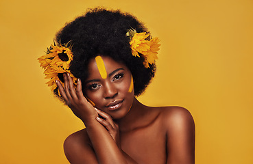 Image showing Natural, sunflower and hair with portrait of black woman in studio for beauty, creative or spring. Makeup, cosmetics and floral with face of model on yellow background for art, self love or glow