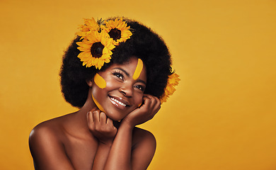 Image showing Hair, sunflower and black woman with natural beauty in studio thinking, happy and relax on yellow background. Flower, haircare and African female model smile while contemplating cosmetic or treatment