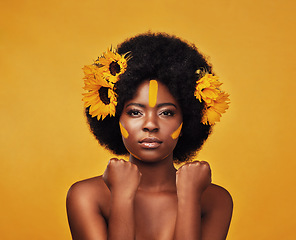 Image showing Makeup, sunflower and hair with portrait of black woman in studio for beauty, creative or spring. Natural, cosmetics and floral with face of model on yellow background for art, self love or glow