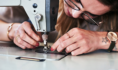 Image showing Sewing machine, woman hands and creative fashion designer with button and thread work. Small business, entrepreneur and female tailor with boutique and employee working with machinery for clothing