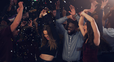 Image showing Friends, celebration and dancing in club with glitter, confetti or new years eve party with happiness, crowd and disco. Dance, people and festival with music, energy and cheering for birthday event