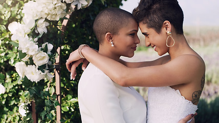 Image showing Love, hug and lgbtq with lesbian couple at wedding for celebration, gay and pride. Smile, spring and happiness with women kiss at marriage event for partner commitment, sexuality and freedom