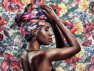 Image showing Fashion, beauty and face of black woman on flower background with glamour, cosmetics and makeup. Floral pattern, designer and profile of female person in exotic jewelry, African style and head scarf