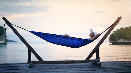 Image showing Hammock, sunset ocean and woman relax outdoor on a vacation, holiday or adventure in nature. Female person on tropical trip, travel and deck with sea, sky and water in summer for zen, peace and calm