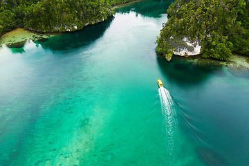 Image showing Travel, top view and boat on island river for adventure, holiday and vacation in Mauritius. Nature, sea and aerial drone of yacht in tropical water for transport, sailing and traveling on islands