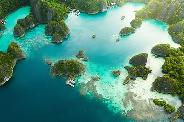 Image showing Travel, aerial and ocean on island for holiday, adventure and vacation on Raja Ampat in Indonesia. Nature, seascape and drone view of tropical water for landscape, environment or traveling on islands