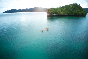 Image showing Adventure, people canoeing and in river on an island together. Summer vacation or holiday break, freedom or journey and couple out on sea paddling on water with mock up space in tropical ocean