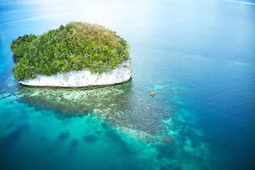 Image showing People, boat and island at sea for kayak adventure, travel or journey in the big blue ocean together. Couple canoeing, kayaking or rowing on calm, peaceful or serene beach water in nature outdoors