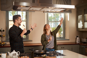 Image showing Food, sing and a funny couple in the kitchen of their home, having fun together while cooking. Karaoke, silly or comic with a man and woman laughing while singing over breakfast in their house