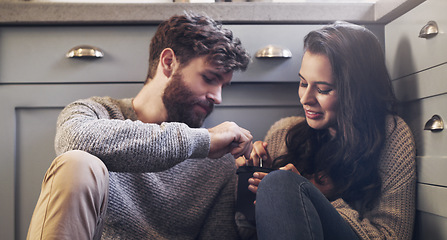 Image showing Ice cream, relax and couple on floor in kitchen for bonding, relaxing and quality time together. Love, relationship and man and woman sharing sweet treats, dessert and luxury snack for romance date