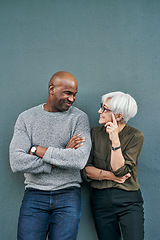 Image showing Professional, talking and wall with blue background have a discussion at work with a friend. Man, woman and business, friendship on outdoor have a conversation about commitment and teamwork.