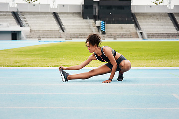 Image showing Woman, fitness and stretching body on stadium track for running, exercise or workout. Active female person or athlete in warm up leg stretch for sports training, athletics or cardio run outdoors