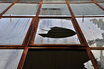 Image showing broken windows with rusty metal frame