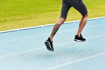 Image showing Man, legs and running on track for athletics, fitness or exercise of athlete training at the stadium. Leg of male person or runner exercising in run, workout or sports competition for healthy cardio