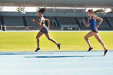 Image showing Woman, running and stadium track of athletes in competition, fitness or athletics in the outdoors. Fit, active or sporty women, runner or sprinting in exercise, workout or training for healthy cardio