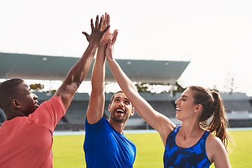 Image showing Diversity, team and high five on stadium track for running, exercise or training together in athletics. Group touching hands in celebration or solidarity for exercising, run or winning in fitness