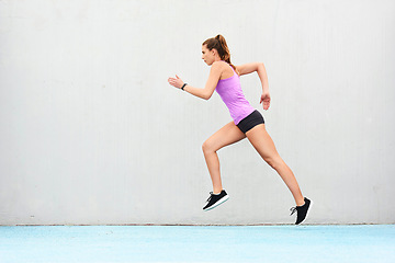 Image showing Woman, fitness and running on mockup for workout, cardio training or healthy exercise outdoors. Fit, active and sporty female person or runner exercising for health and wellness on wall mock up space